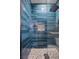 Bright, updated shower featuring blue subway tile, mosaic tile niche, and glass door, offering a spa-like experience at 3428 Royal Calloway Ave, Las Vegas, NV 89141