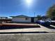 A single-story home with a front yard and a covered vehicle in the driveway under a bright, sunny sky at 3505 W Bonanza Rd, Las Vegas, NV 89107