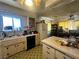 A cozy kitchen with a retro ceiling fan, classic tile flooring, and vintage appliances at 3505 W Bonanza Rd, Las Vegas, NV 89107