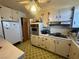A compact kitchen with classic cabinets, retro tile flooring, and functional appliances at 3505 W Bonanza Rd, Las Vegas, NV 89107