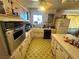 A vintage kitchen featuring built-in appliances, classic tile flooring, and neutral cabinets at 3505 W Bonanza Rd, Las Vegas, NV 89107