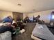 Untidy living room with fireplace and disorganized furnishings, needs cleaning at 3505 W Bonanza Rd, Las Vegas, NV 89107