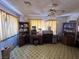 A cozy living room featuring vintage flooring, classic curtains, and built-in wooden shelving at 3505 W Bonanza Rd, Las Vegas, NV 89107
