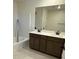 Bathroom features a double sink vanity with dark brown cabinetry and tile floors at 3667 Inspirato Ave, Henderson, NV 89044