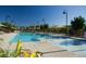 Community pool with lounge seating and lush landscaping at 3667 Inspirato Ave, Henderson, NV 89044
