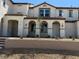 Attractive multi-level home with stucco exterior, red tile roof, arched entryways and manicured landscaping at 3667 Inspirato Ave, Henderson, NV 89044