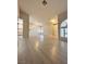 Spacious living room featuring light wood floors, neutral paint, arched windows, and plenty of natural light at 3672 Angela Robin St # 202, Las Vegas, NV 89129