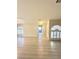 Open living room featuring tiled entry, wood laminate flooring, and arched windows at 3672 Angela Robin St # 202, Las Vegas, NV 89129