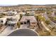 An aerial view shows the property with a putting green, pool, and desert landscaping at 39 Cranberry Cove Ct, Las Vegas, NV 89135