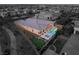 An aerial view of a modern house with a swimming pool and putting green in the backyard of a gated community at 39 Cranberry Cove Ct, Las Vegas, NV 89135