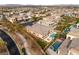 An aerial view showcases a luxurious property with a pool, putting green, and desert landscaping at 39 Cranberry Cove Ct, Las Vegas, NV 89135