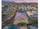 Striking aerial perspective of the property with a pool, putting green, and stunning mountain views at 39 Cranberry Cove Ct, Las Vegas, NV 89135