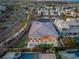 A captivating aerial view of the house with pool, putting green, lush landscaping, and the scenic community at 39 Cranberry Cove Ct, Las Vegas, NV 89135