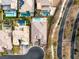 An aerial view shows a luxurious property with a pool, putting green, and desert landscaping at 39 Cranberry Cove Ct, Las Vegas, NV 89135