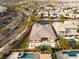 This aerial view shows a beautiful property with a pool, putting green, and mountain views at 39 Cranberry Cove Ct, Las Vegas, NV 89135