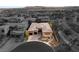 A high-angle view of the home with a putting green, desert landscaping and a mountain backdrop at 39 Cranberry Cove Ct, Las Vegas, NV 89135