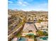 An aerial view shows a desert property with a pool, putting green, and mountain views at 39 Cranberry Cove Ct, Las Vegas, NV 89135