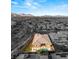 Beautiful aerial view of a home with a private pool, putting green and desert landscaping with mountain views at 39 Cranberry Cove Ct, Las Vegas, NV 89135