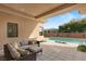 Relaxing outdoor area with wicker seating, a pristine pool, and ample lounging space at 39 Cranberry Cove Ct, Las Vegas, NV 89135