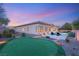 Lush backyard oasis featuring a putting green, lounge chairs, a swimming pool, and mature landscaping at 39 Cranberry Cove Ct, Las Vegas, NV 89135
