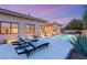 Serene backyard featuring a swimming pool, lounge chairs, and beautifully manicured landscaping at 39 Cranberry Cove Ct, Las Vegas, NV 89135