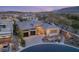 Modern home featuring a three-car garage, stylish landscaping, and well-lit exterior at 39 Cranberry Cove Ct, Las Vegas, NV 89135