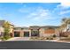 Contemporary desert home featuring desert landscaping, large windows and three car garage at 39 Cranberry Cove Ct, Las Vegas, NV 89135