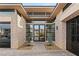 Elegant double door entry with stone accents and desert landscaping at 39 Cranberry Cove Ct, Las Vegas, NV 89135