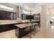Spacious kitchen with tile flooring, stainless appliances, granite counters and a large island with seating at 39 Cranberry Cove Ct, Las Vegas, NV 89135