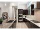 Stylish kitchen features modern appliances, dark wood cabinets and an island with granite counters at 39 Cranberry Cove Ct, Las Vegas, NV 89135