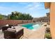 Private pool area with lounge chairs, decorative sconces, and lush landscaping for a serene escape at 39 Cranberry Cove Ct, Las Vegas, NV 89135