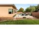 The backyard features a modern pool and putting green, surrounded by desert landscaping at 39 Cranberry Cove Ct, Las Vegas, NV 89135