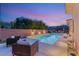 Relaxing outdoor lounge by the pool, surrounded by refined greenery and ambient lighting at 39 Cranberry Cove Ct, Las Vegas, NV 89135