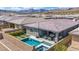 An aerial view of a home featuring a pool, landscaping and outdoor living space at 440 Point Sur Ave, Las Vegas, NV 89138