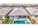 Aerial view of a home with a sparkling backyard pool and spa, surrounded by lush landscaping and stylish outdoor seating at 440 Point Sur Ave, Las Vegas, NV 89138