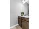Modern bathroom boasts single sink with wooden cabinetry and white countertop at 440 Point Sur Ave, Las Vegas, NV 89138