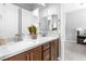 Modern bathroom boasts double sinks with wooden cabinetry and white countertop at 440 Point Sur Ave, Las Vegas, NV 89138