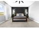 Modern bedroom boasts a stylish accent wall, neutral colors, and plenty of natural light at 440 Point Sur Ave, Las Vegas, NV 89138