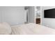 Bright bedroom with warm-toned walls, with ensuite bathroom and large screen TV at 440 Point Sur Ave, Las Vegas, NV 89138