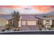 A modern home featuring a three-car garage and well-manicured landscaping at 440 Point Sur Ave, Las Vegas, NV 89138