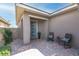 Inviting covered front porch with chairs and brick flooring at 440 Point Sur Ave, Las Vegas, NV 89138
