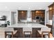 Bright kitchen features dark wood cabinetry, stainless appliances, and large island with seating at 440 Point Sur Ave, Las Vegas, NV 89138