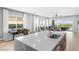 Open-concept kitchen and living area with a quartz island and backyard views at 440 Point Sur Ave, Las Vegas, NV 89138