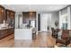 Kitchen with large island and sink, stainless steel appliances, dark wood cabinetry and eating nook at 440 Point Sur Ave, Las Vegas, NV 89138
