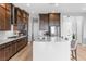 Kitchen with large island and sink, stainless steel appliances, dark wood cabinetry and eating nook at 440 Point Sur Ave, Las Vegas, NV 89138