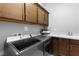 Functional laundry room with washer, dryer, cabinetry, sink and countertop space at 440 Point Sur Ave, Las Vegas, NV 89138