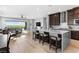 Open-concept living space featuring a kitchen island and sliding doors to the backyard at 440 Point Sur Ave, Las Vegas, NV 89138