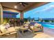 A covered patio featuring comfortable seating with barstools and a ceiling fan at 440 Point Sur Ave, Las Vegas, NV 89138