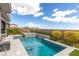 Backyard pool and spa combination with patio, lush landscaping and blue skies at 440 Point Sur Ave, Las Vegas, NV 89138