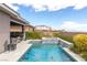An outdoor pool and spa combination with rock waterfall feature with lush landscaping at 440 Point Sur Ave, Las Vegas, NV 89138